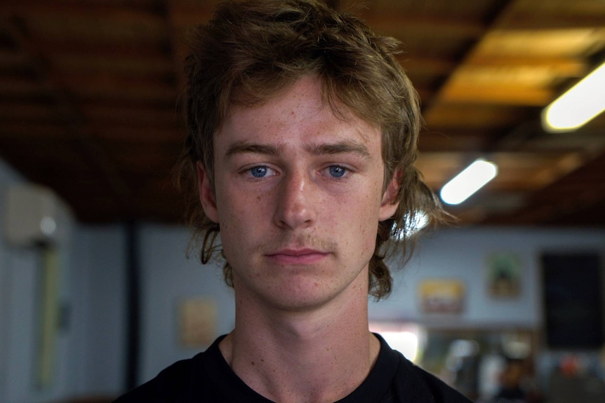 Boy with blue eyes and blonde hair looking at camera 