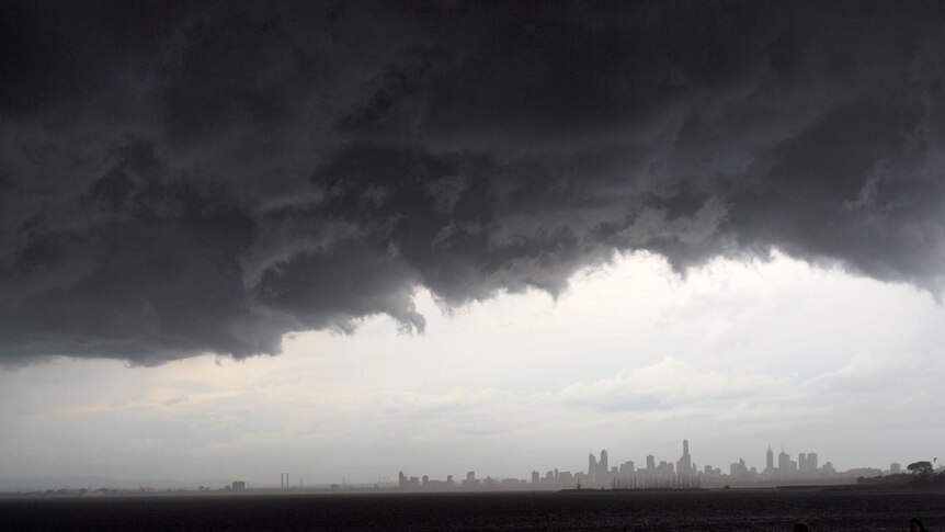 A large storm cloud hangs over Port Phillip Bay as it sweeps into Melbourne.