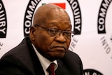 Jacob Zuma looks in the direction of the camera with an unhappy expression on his face.