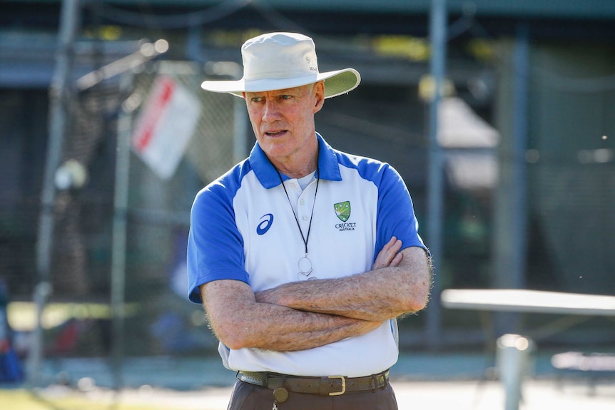 Greg Chappell stands with his arms crossed during training.