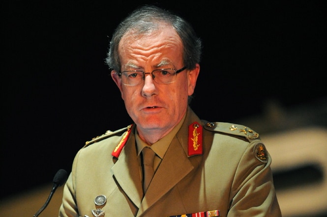 Major General Brereton is pictured giving a speech in his military uniform. He's standing behind a lectern, and is mid sentence.
