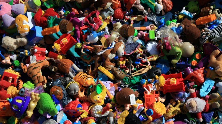 a jumble of small plastic children's toys lies spread across a table, there is no surface visible except all these crazy toys