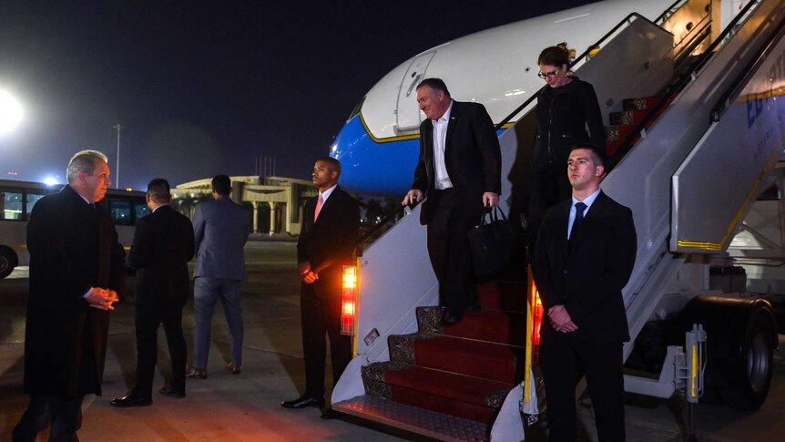 U.S. Secretary of State Mike Pompeo walks down the stairs of an aircraft at Cairo airport