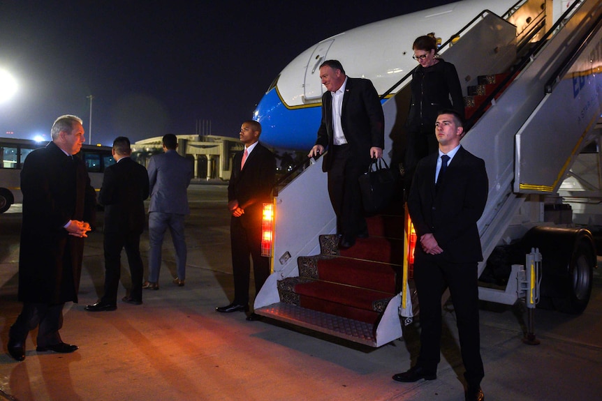 U.S. Secretary of State Mike Pompeo walks down the stairs of an aircraft at Cairo airport