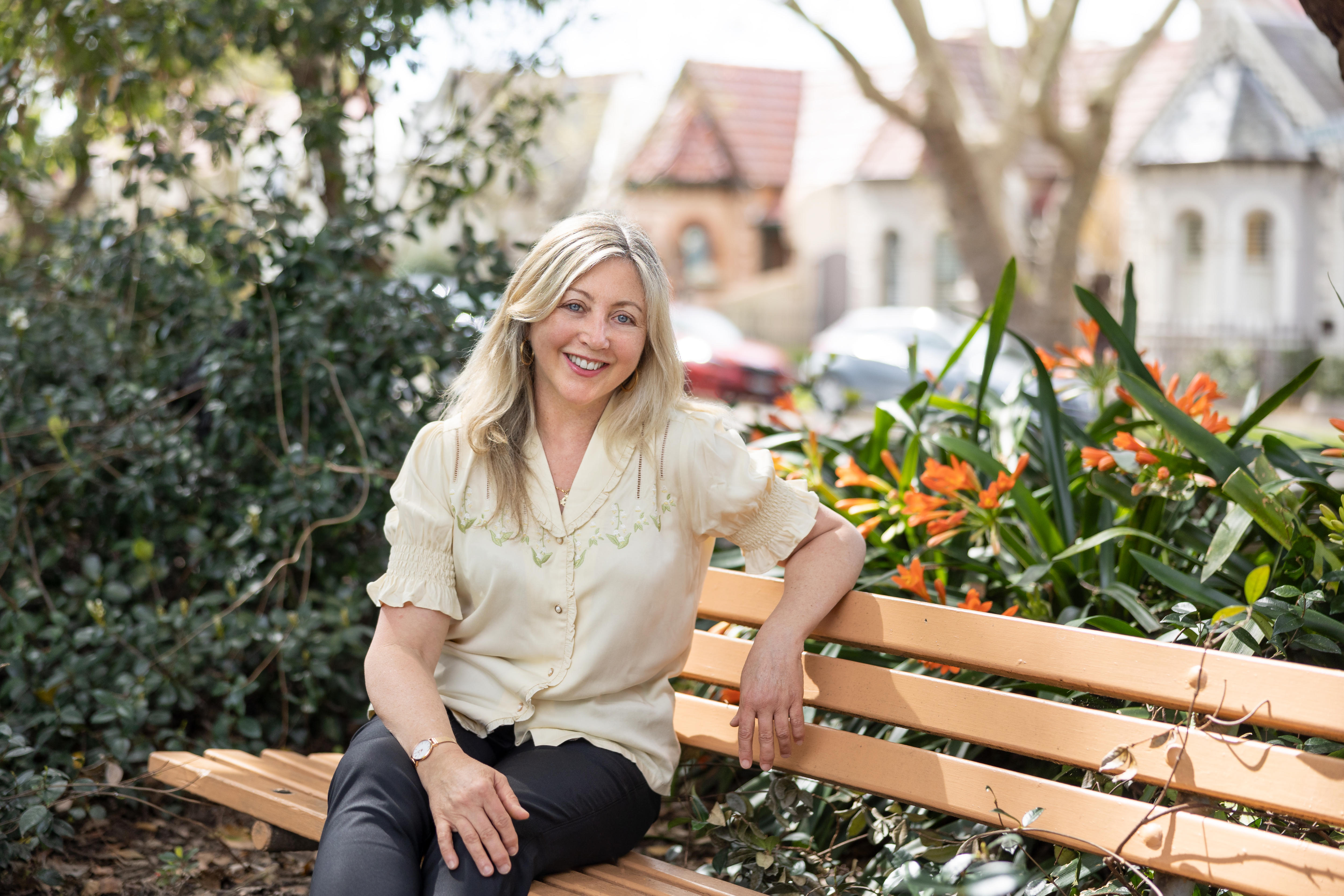 A woman sits on a bench