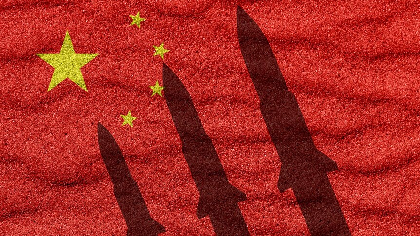The shadow of three missiles set against a Chinese flag