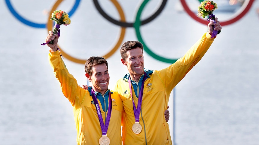 Mathew Belcher and Malcolm Page pose with their Olympics gold medals won in the men's 470 sailing.