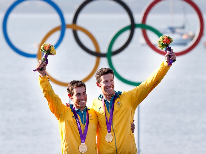 Mathew Belcher and Malcolm Page pose with their Olympics gold medals won in the men's 470 sailing.