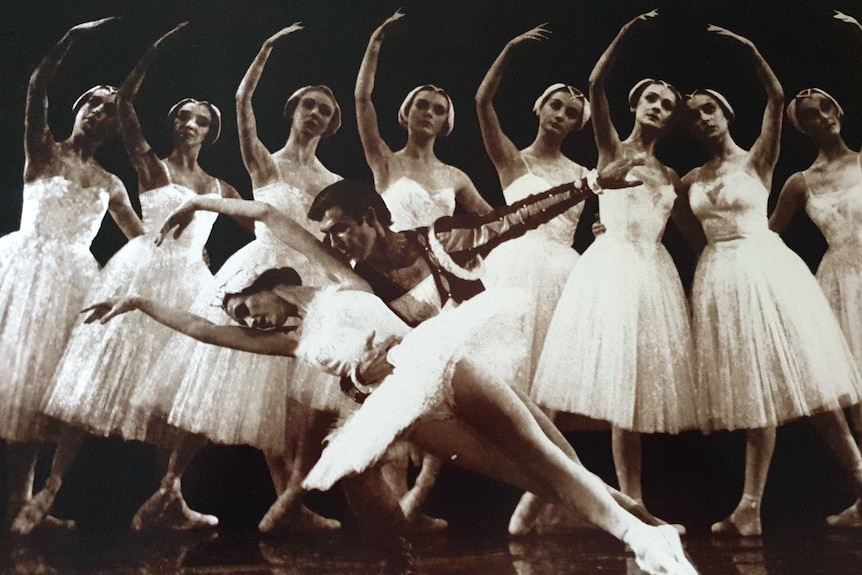 A black and white image of two ballet dancers, with a man holding a woman.