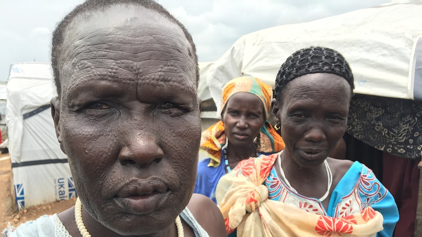 Three women in South Sudan, with tribal scarring on their faces.