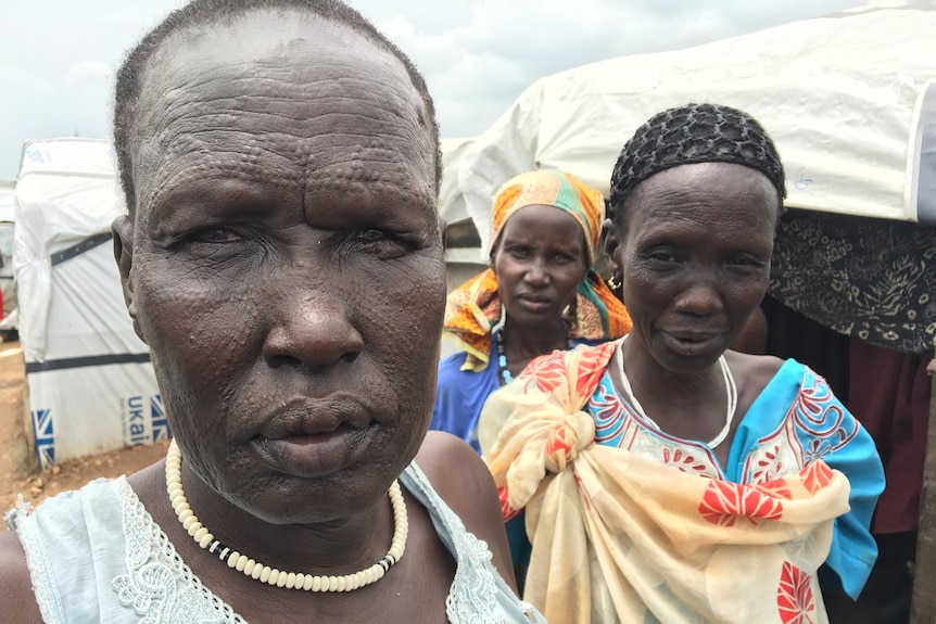 Three women in South Sudan, with tribal scarring on their faces.