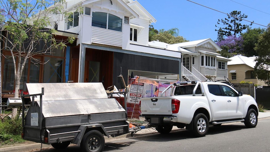 Carpenter trailer parked outside site of old Queenslander-style house renovation site in a Brisbane suburb on October 31, 2018.