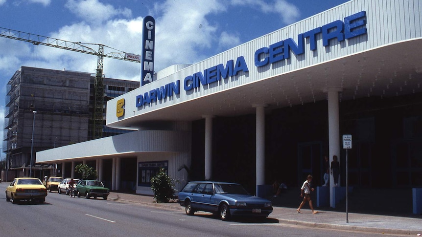 An archival photo of a cinema in a sunny Darwin street.