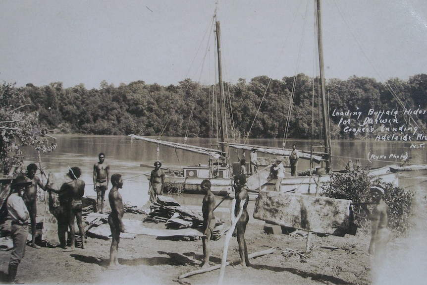 Men loading a boat on a river.