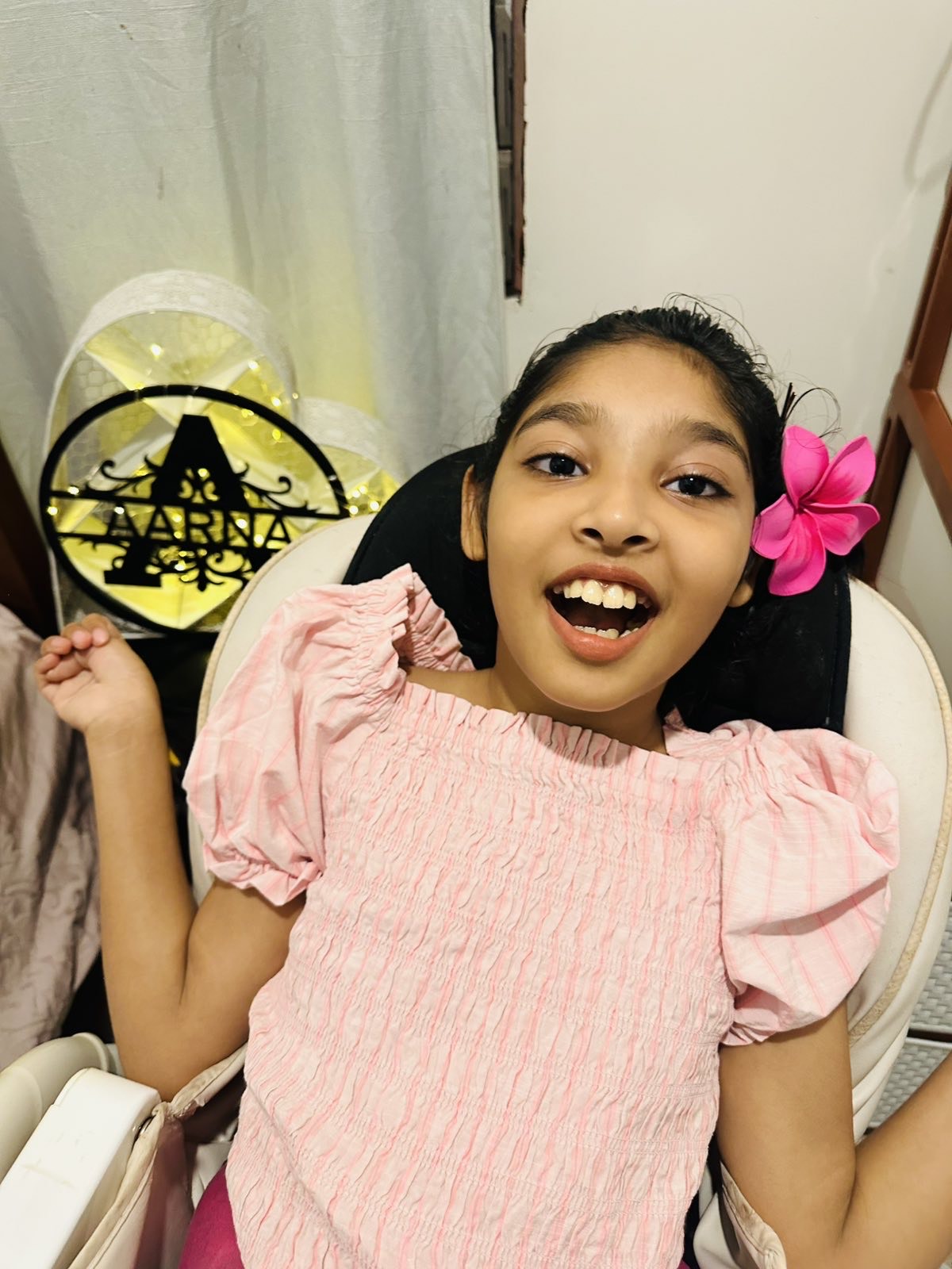 Ten-year-old Aarana, was born with cerebral palsy, smiles for the camera.