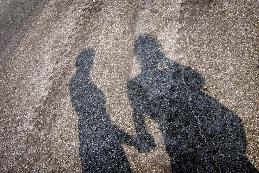 The shadow of two teenagers holding hands