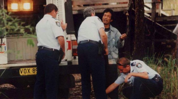 Police arrest a suspected asylum seeker at Scotts Head in 1999