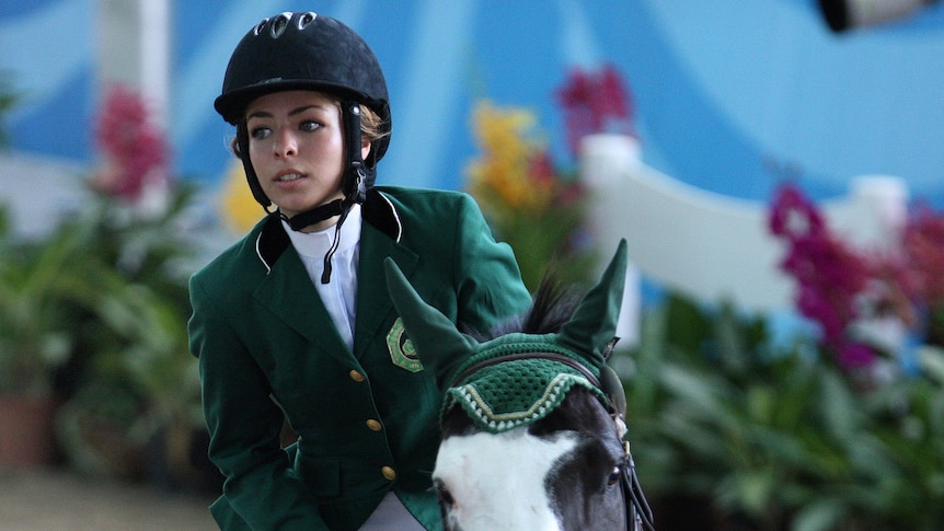 Dalma Rushdi Malhas of Saudi Arabia rides the horse Flash Top Hat at the 2010 Youth Olympic Games.