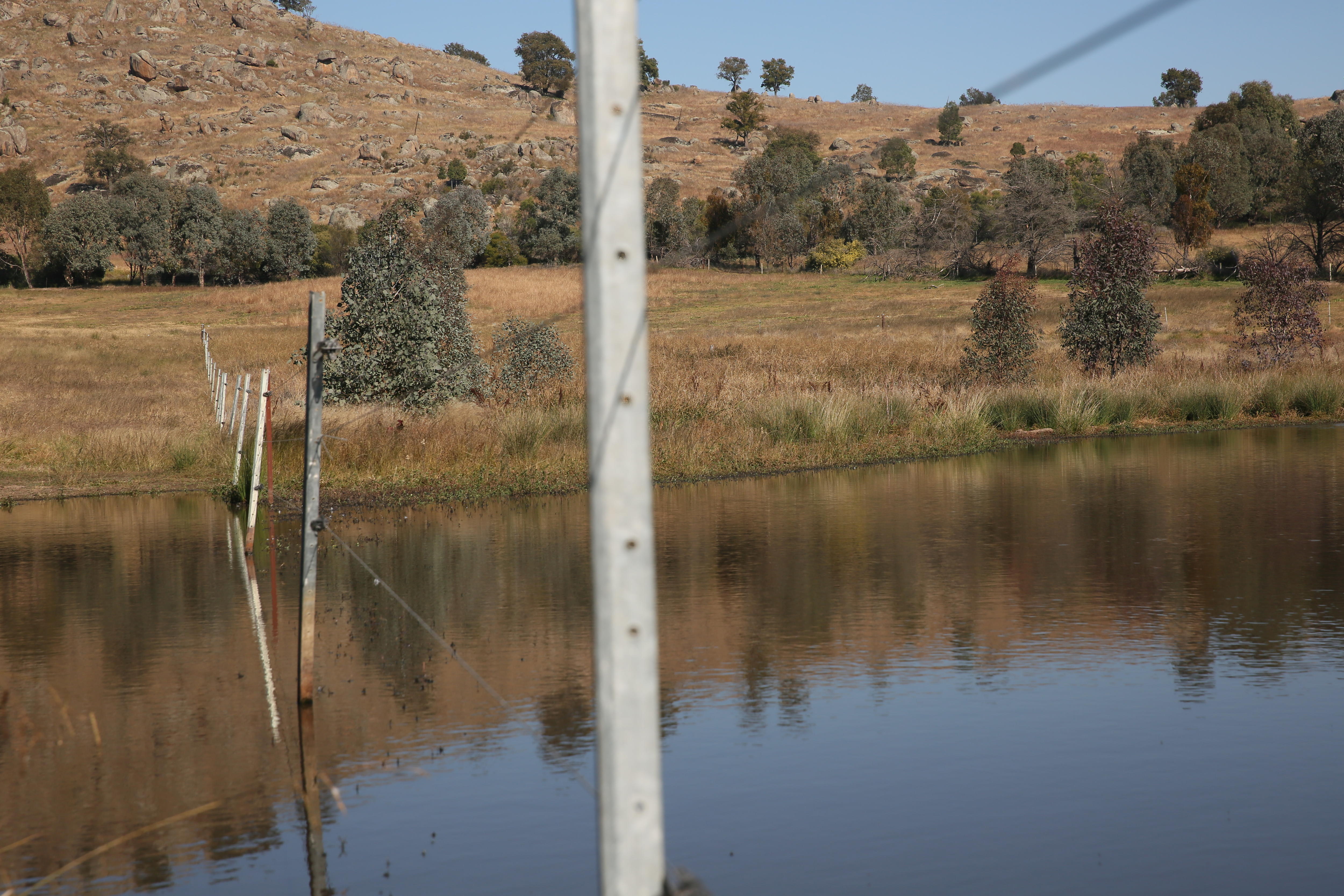 A dam with a fence running through it.