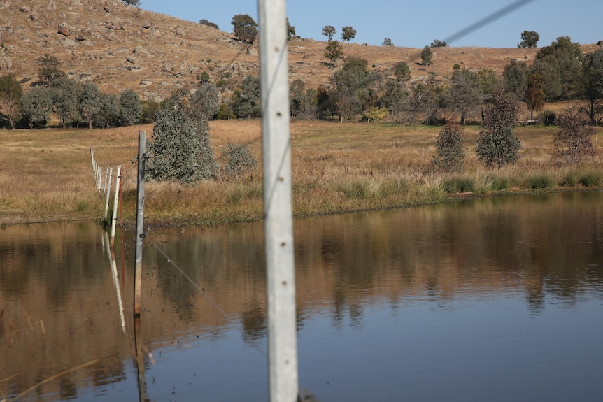 A dam with a fence running through it.