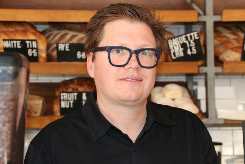 A head and shoulders shot of Mary Street Bakery co-owner Michael Forde posing for a photo in the bakery wearing a black shirt.