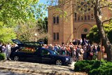 Mourners outside Luke Dorsett and Kate Goodchild's funeral at St Christopher's Cathedral at Forrest in Canberra's inner-south.