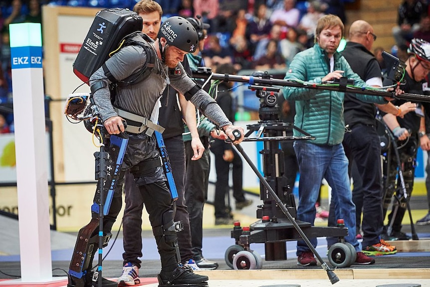 A man in a bionic exoskeleton competes in a race