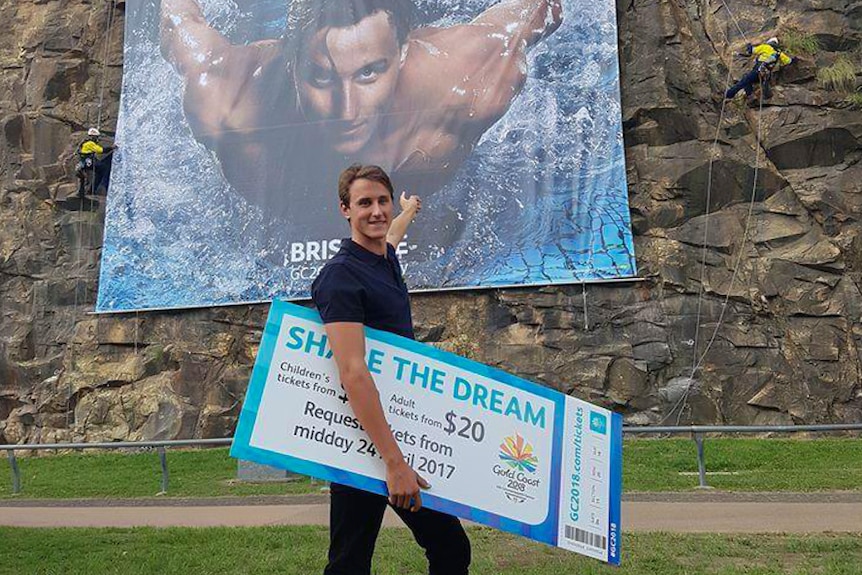 Athlete holds Commonwealth Games ticket.