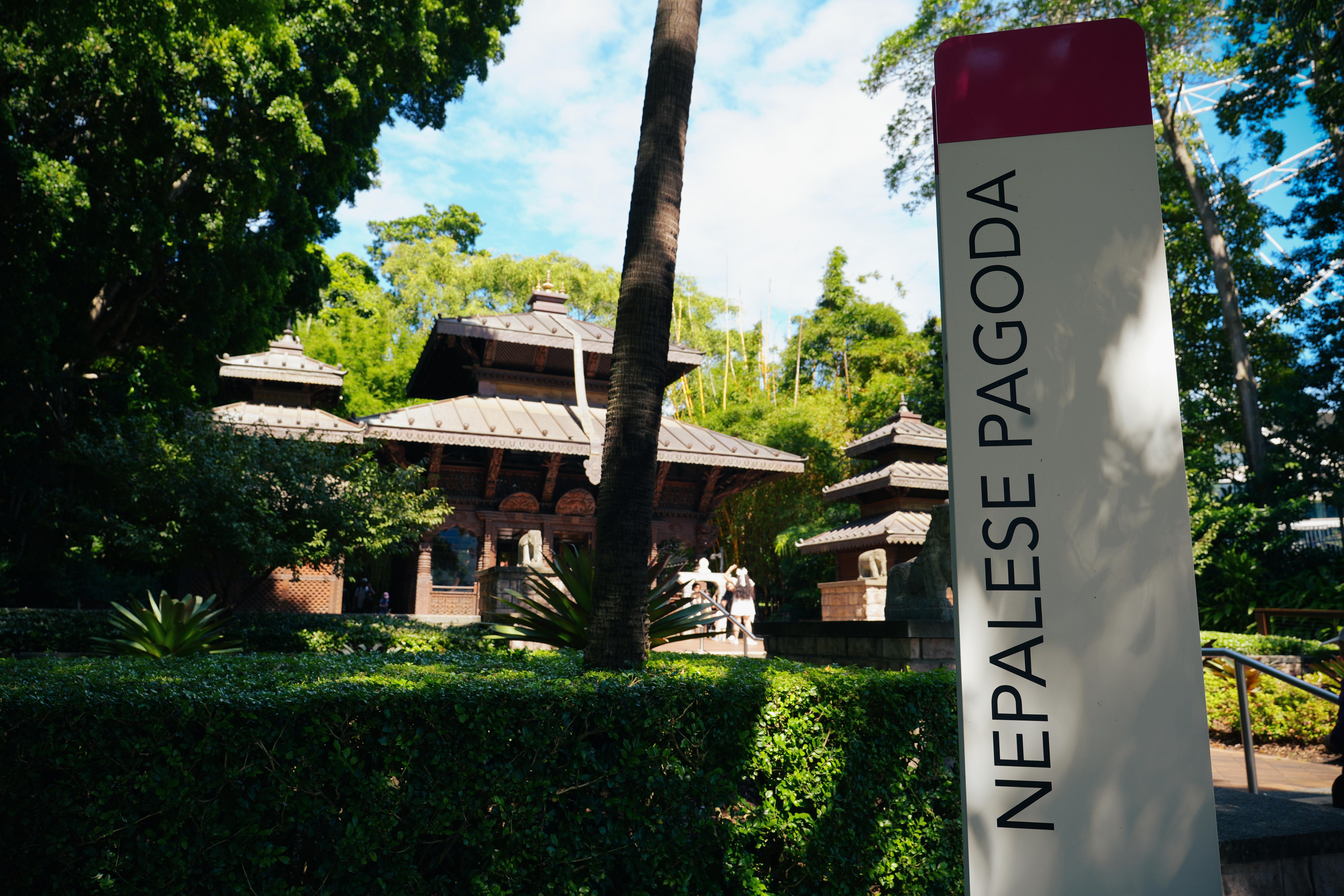 Photo of Nepalese Pagoda sign with the temple in the background, as found in Brisbane.