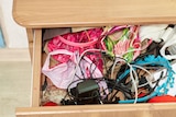 A drawer with random household items