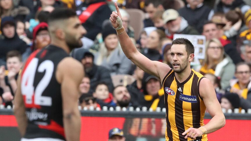 Jack Gunston of the Hawks reacts after kicking a goal against Essendon at the MCG.