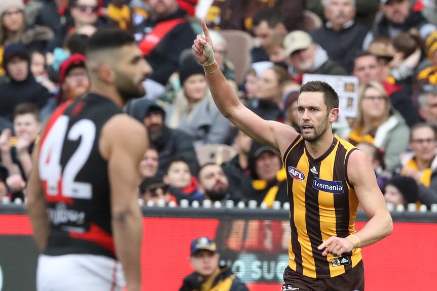 Jack Gunston of the Hawks reacts after kicking a goal against Essendon at the MCG.