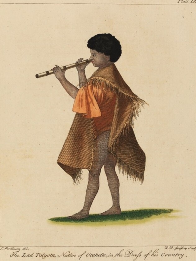 A boy plays a nose flute.