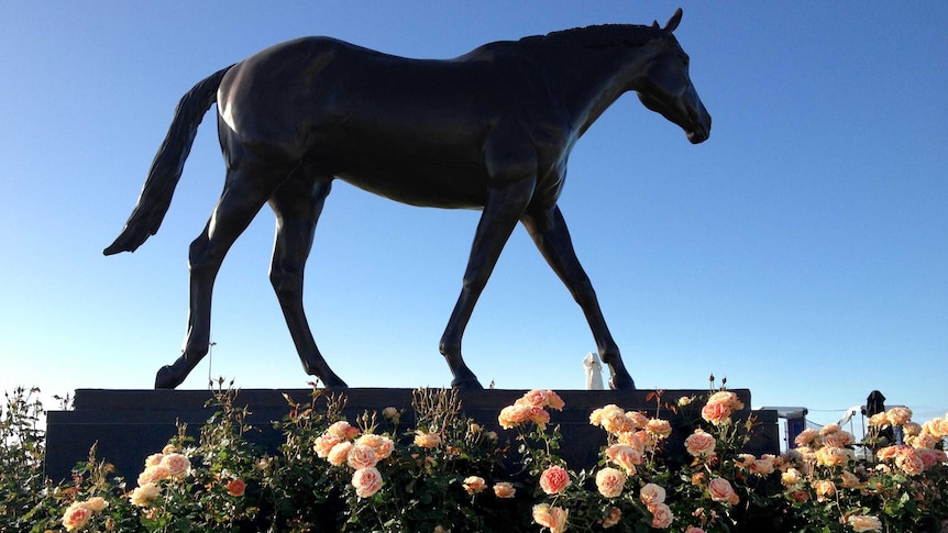 Roses surround the statue of Makybe Diva at Flemington racecourse on Melbourne Cup day.