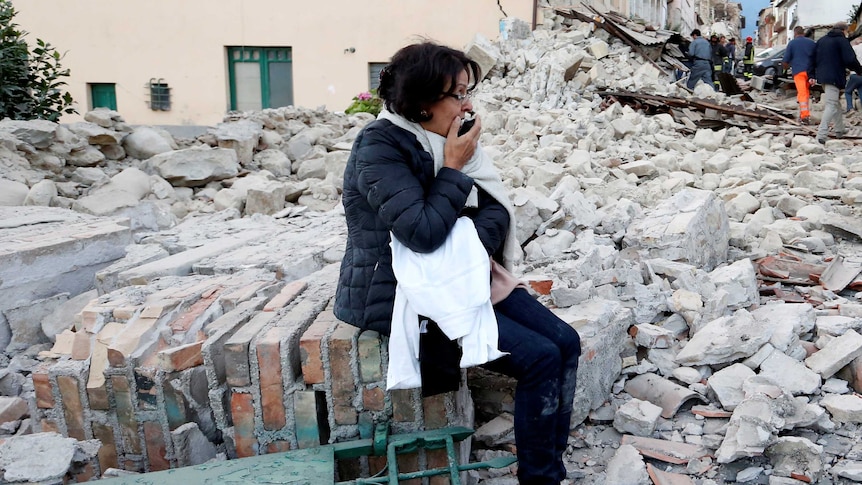A woman among rubble following a quake in Amatrice, central Italy, on August 24, 2016.