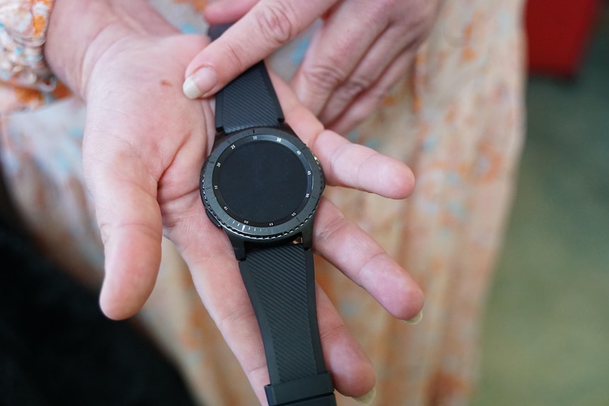 A safety watch in a woman's hands