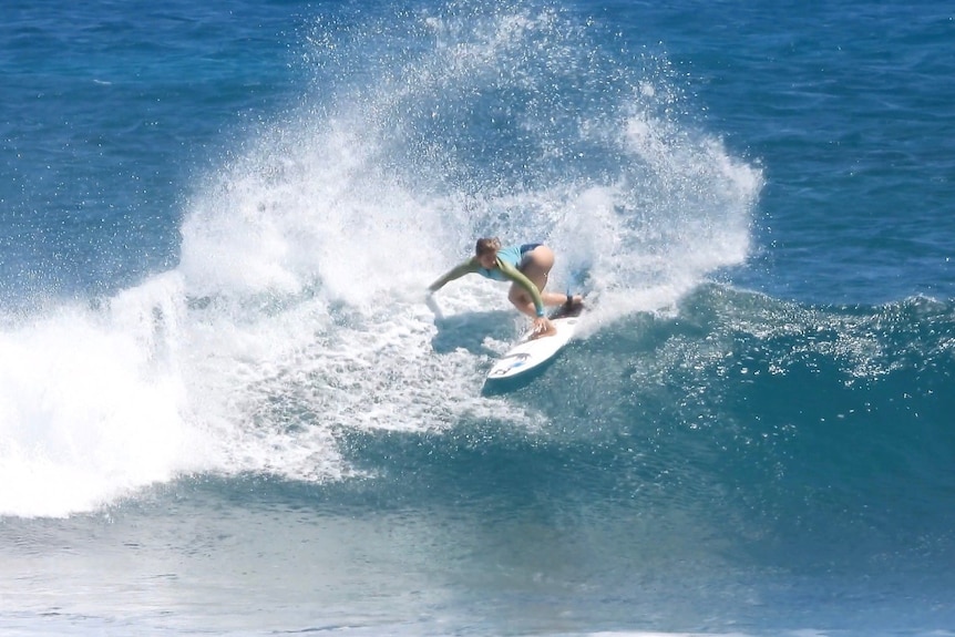 A woman surfing on a wave