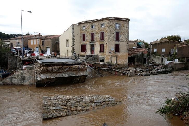 Remnants of a destroyed  bridge with strong river currents flowing below