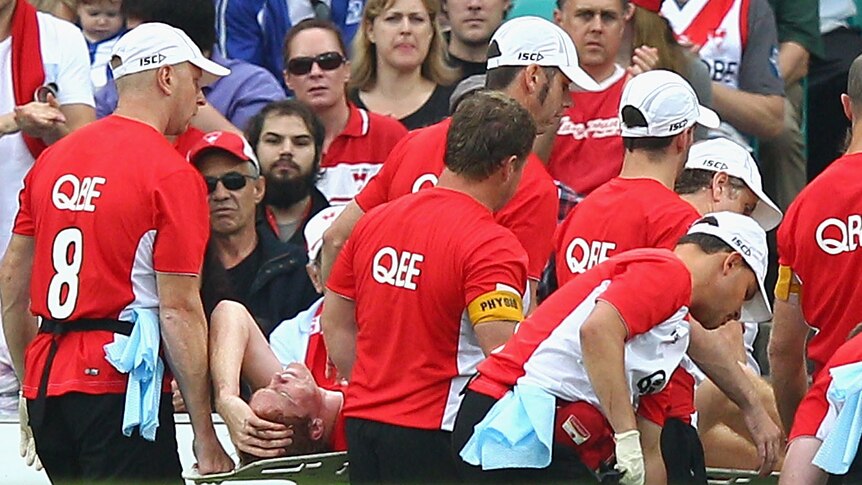 The Swans' Gary Rohan is carried off with a suspected broken ankle in Sydney's win over North Melbourne