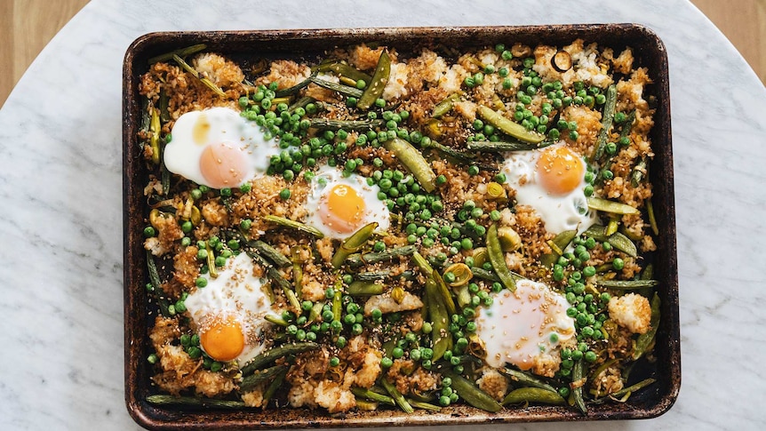 Vegetarian fried rice that's baked on a tray with eggs, peas, beans, sugar snap peas, leek and asparagus, an easy family dinner.