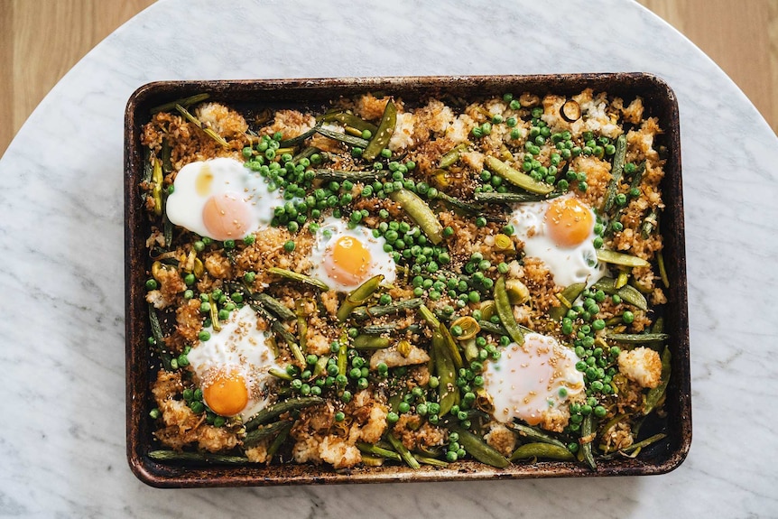 Vegetarian fried rice that's baked on a tray with eggs, peas, beans, sugar snap peas, leek and asparagus, an easy family dinner.