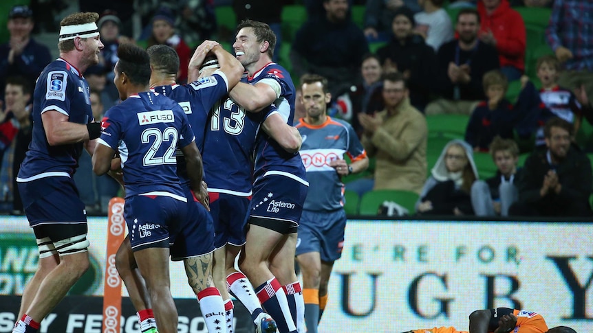 Try time ... The Rebels celebrate a Reece Hodge five-pointer