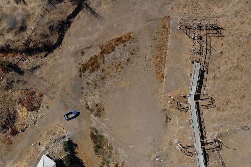 A boat sits on dry land in this aerial image.