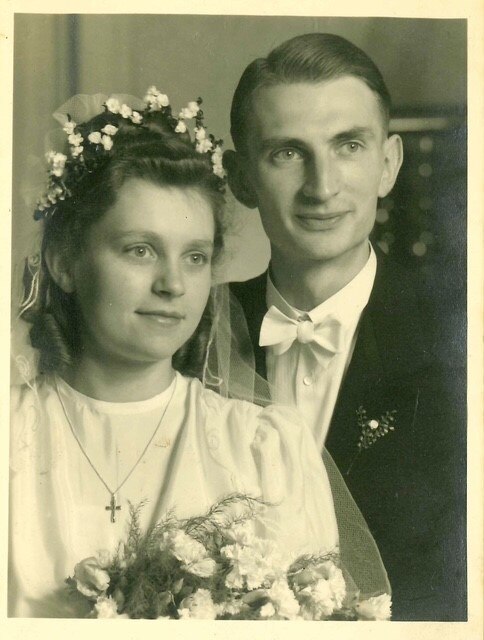 A black and white photo of a couple on their wedding day.