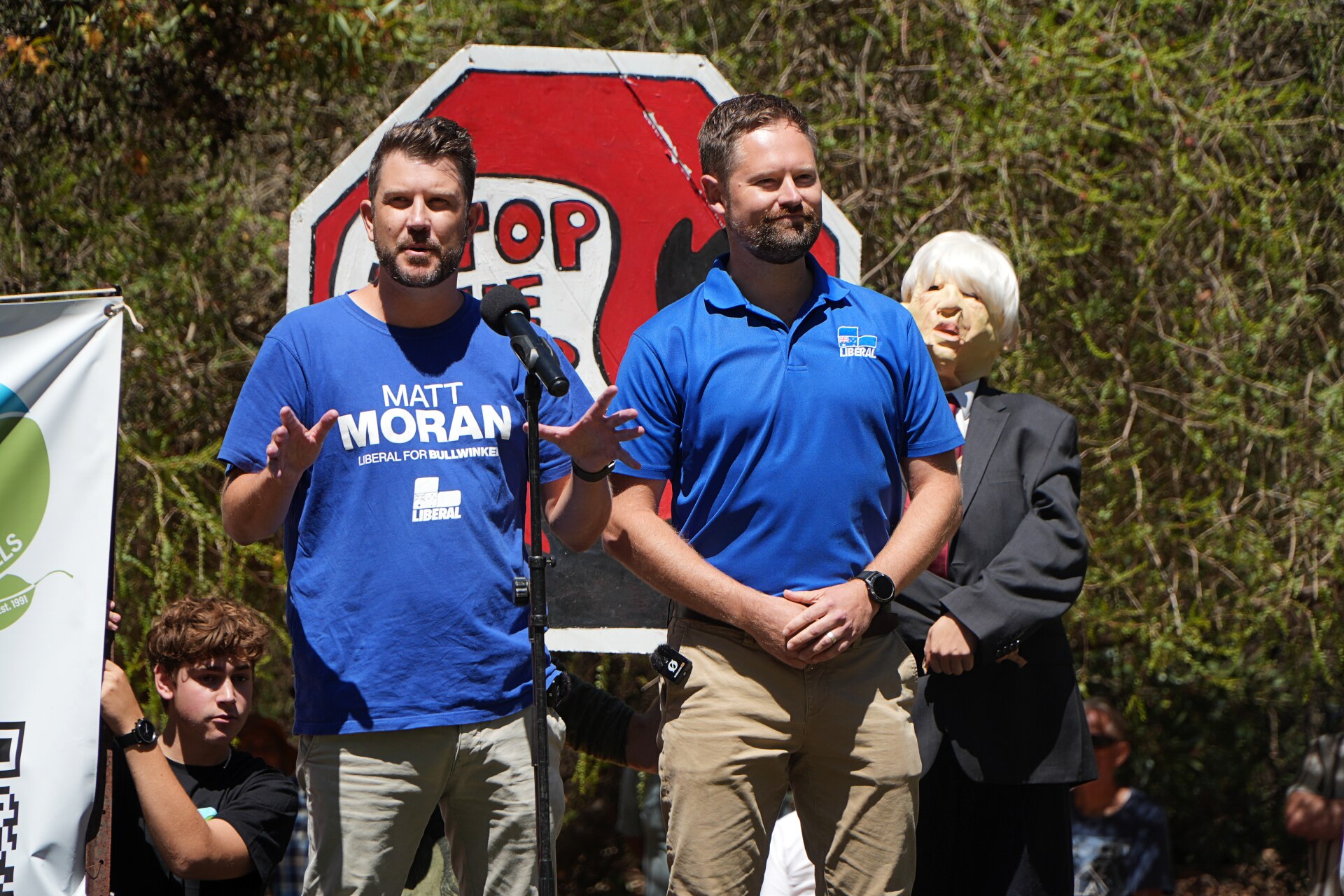 Matt Moran and Adam Hort speaking to a rally dressed in Liberal candidate shirts.