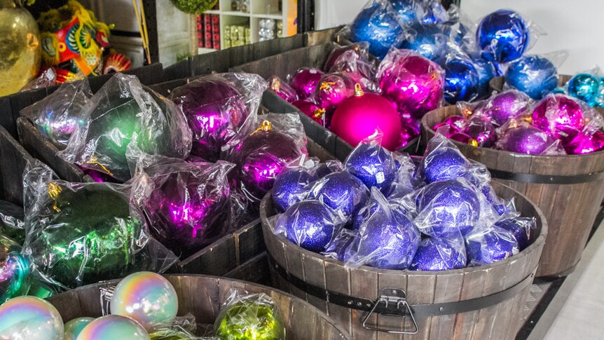 Buckets of baubles the size of basketballs are sorted in colour to make it easy for hanging.