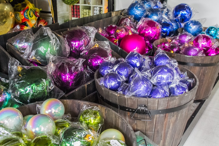 Buckets of baubles the size of basketballs are sorted in colour to make it easy for hanging.