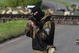 A Ukrainian soldier points his weapon at an approaching car at a checkpoint near the town of Slaviansk in eastern Ukraine.