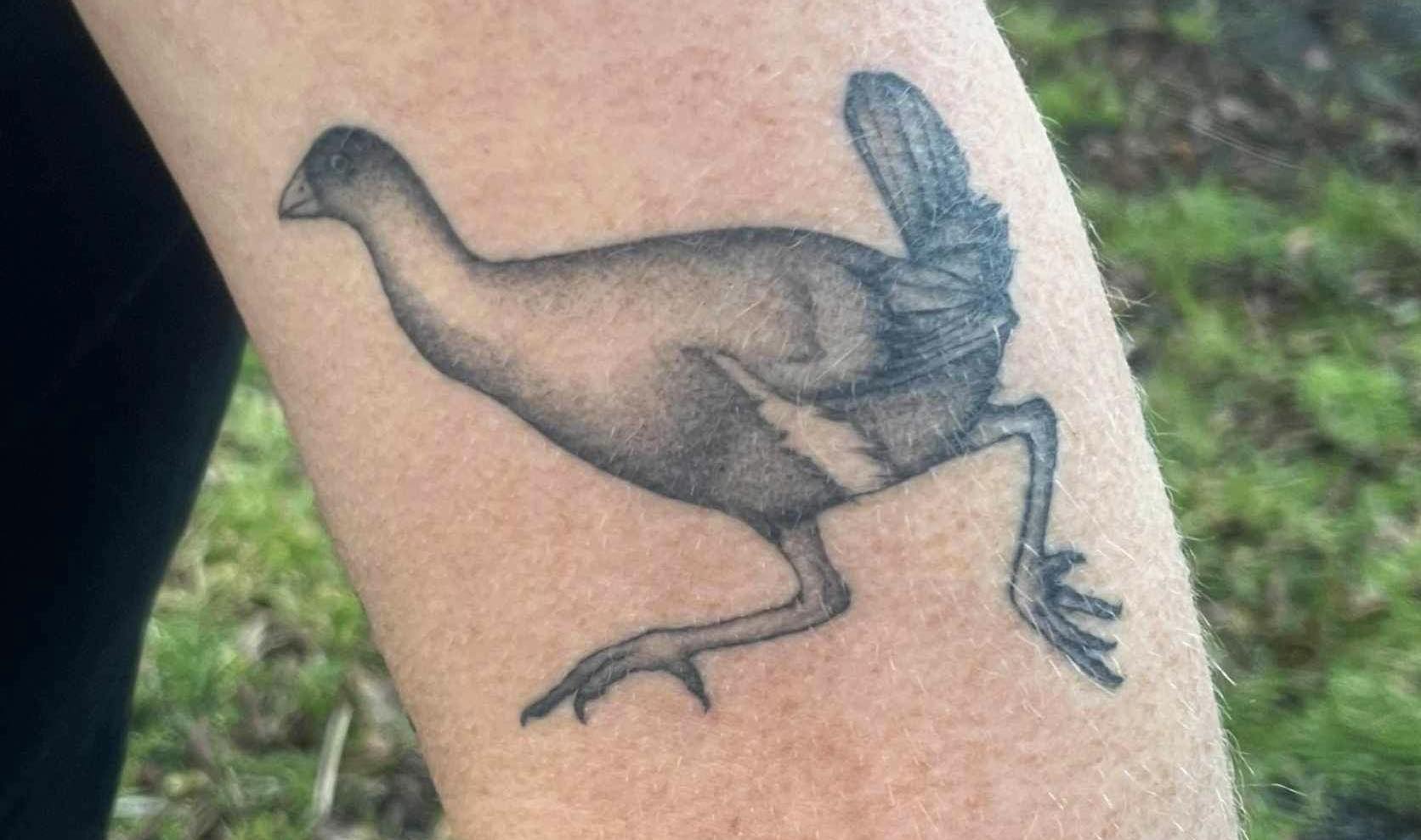 Artm tattooed with a black and white running bird 