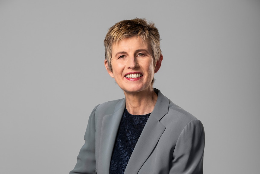 Bronwyn Evans wearing a grey suit and smiling in a business-like portrait.